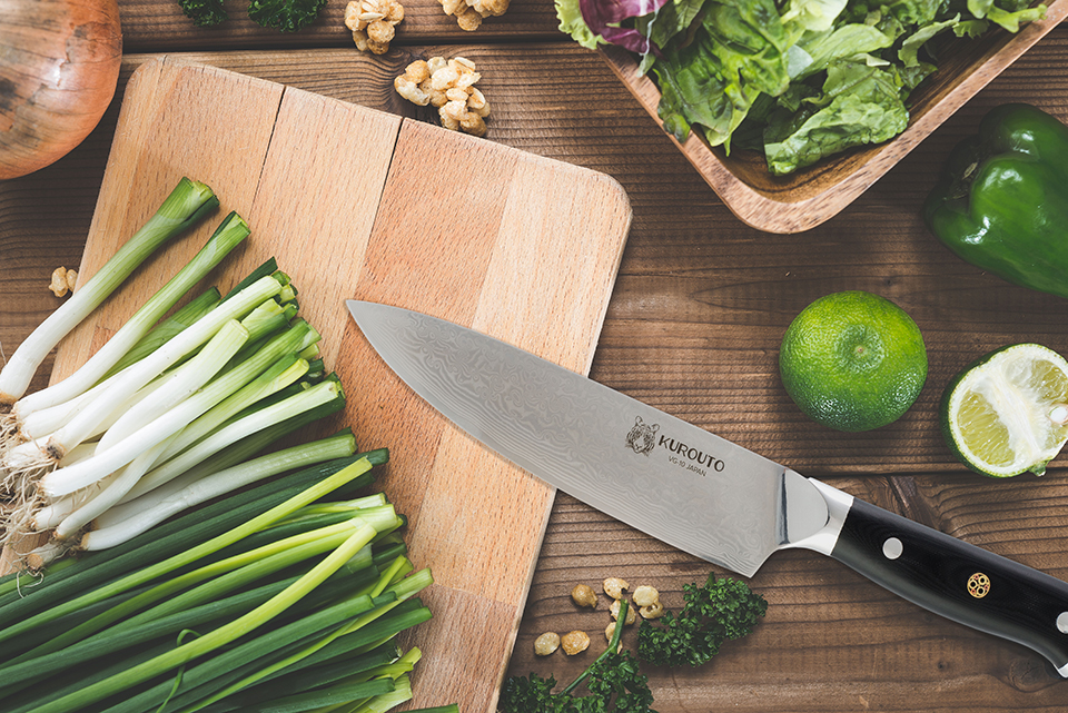 Kurouto Kitchenware Chef's Knife Kitchen Flatlay with Green Onions and Limes