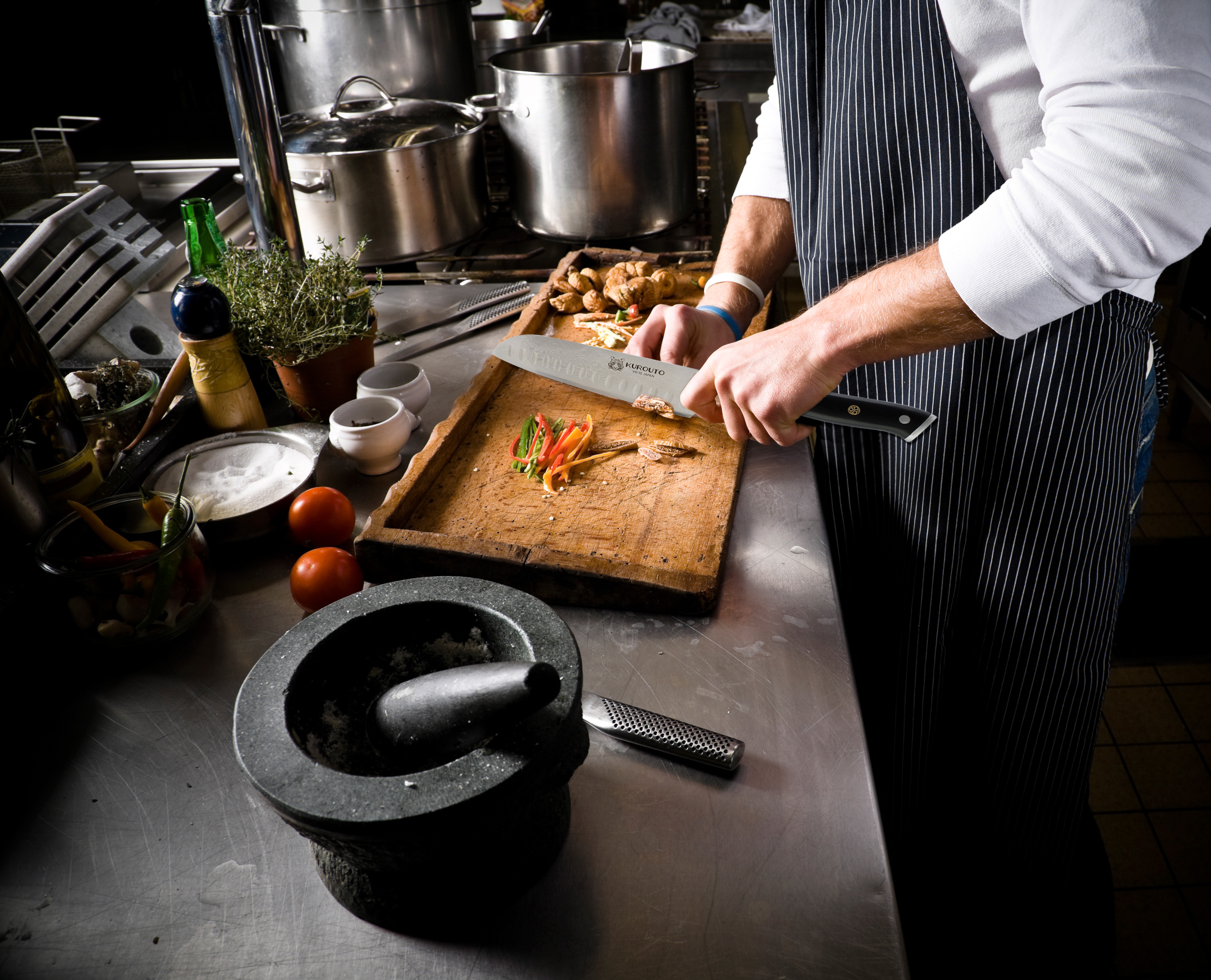 Kurouto Kitchenware Santoku Knife Chopping Vegetables in a Restaurant Kitchen